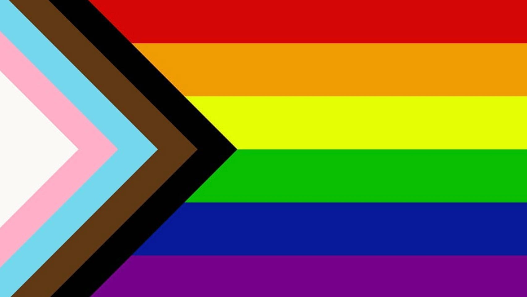 Progress Pride flag with rainbow stripes (red, orange, yellow, green, blue, purple) and a chevron at the left with black, brown, light blue, pink, and white stripes representing inclusion and diversity.